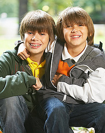 smiling young brothers with braces
